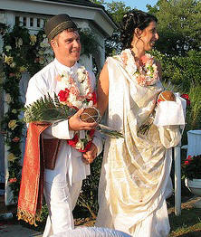 Groom wears a dugli and the woman a white sari