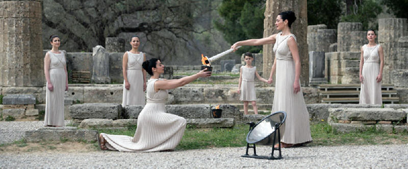 Actress Maria Nafpliotou (at right) as the high priestess, lights the urn in front of the ruins of goddess Hera's temple at Olympia on March 23, 2008