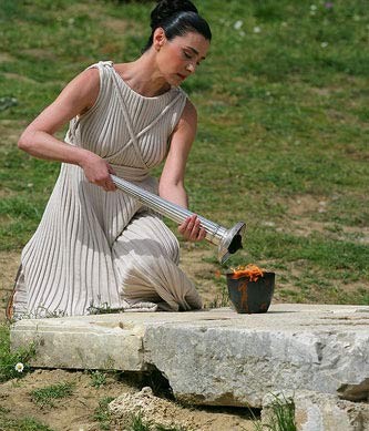 urn to torch at the stadium altar
