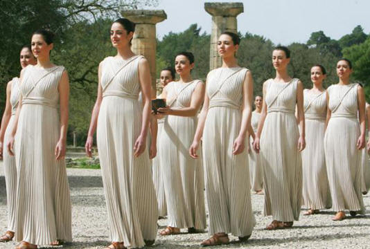 The high preistess carrying the flame in the procession