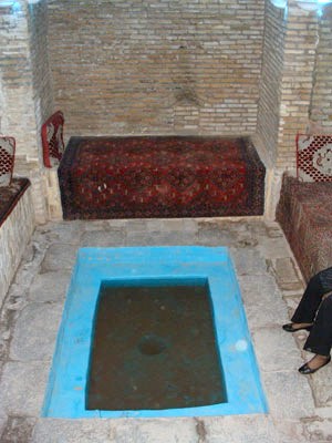 Basement room with a small pool to cool the breeze coming in from a badgir