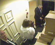 Black, assistant Joan Maida and chauffeur John Hillier removing boxes from Hollinger Inc.
