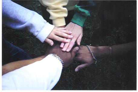 Arms reaching out, hands placed on top of each other