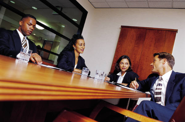 Group of individyals of different ethnic backgrounds sitting around a table